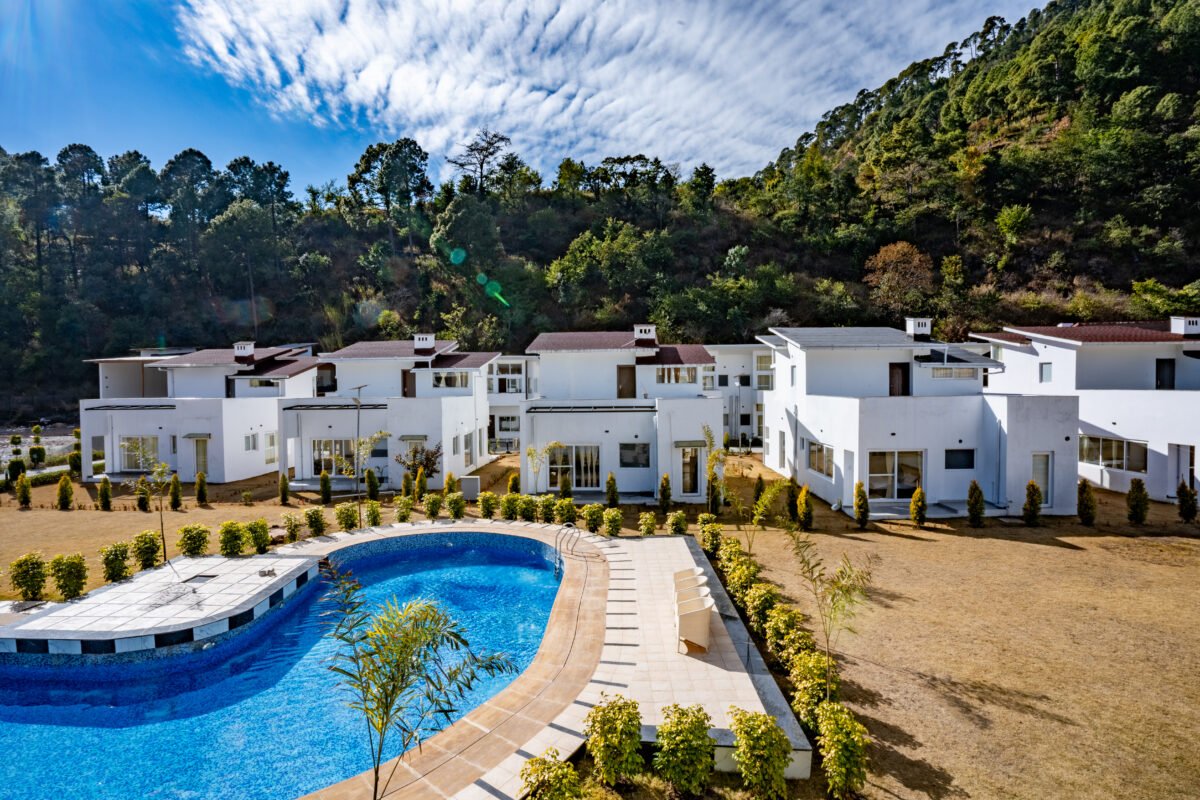 White chalets and swimming pool at 3R Stays in Bhowali