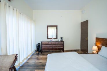 A bright bedroom with white bedding at 3R Stays