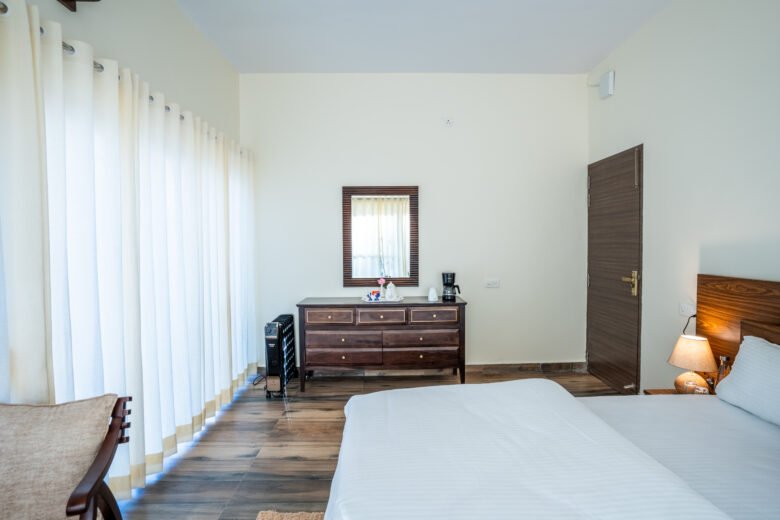A bright bedroom with white bedding at 3R Stays